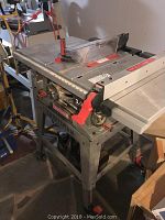 Overview of Craftsman 10 inch table saw showing metal table top, blade guard, fence, and red adjustments