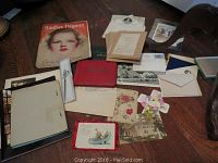 Overview of the collection laid out on a table showing magazine, cards, envelopes, letters and autograph books.