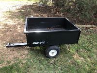 Side view of the Blue Hawk trailer wagon showing rectangular black steel cargo area, pneumatic tires, and metal hitch for attachment.