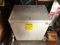 Front and top view of white Kenmore chest freezer showing surface soiling and detachable lid.