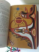 Open Bible showing a full-page Native American style illustration with symbolic and colorful artwork