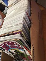 Box full of comics showing Sensational She-Hulk on cover visible on top