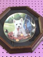 Photo of framed collector plate showing the full octagonal wooden frame with glass covering and the collector plate inside.