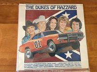 Front cover of The Dukes of Hazzard vintage vinyl showing illustrated characters and car with number 01.