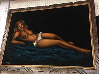 Front view of the framed velvet painting showing the reclining nude woman on a blue textured velvet background.