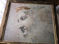 Framed square artwork showing a classical artistic profile of a head surrounded by Roman numerals and abstract marks in a muted color palette.