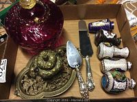 Overview of cranberry glass candy dish, brass dish, cake server, cheese knife and cloisonne vases