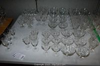 Table of 61 clear glass sherbert, aperitif and wine glasses with textured patterns typical of cornflower style.