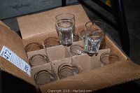 Box of 24 glasses with dividers showing multiple clear glasses with Harp and Guinness branding.