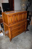Full view of wooden dresser showing upper cabinet with four doors and lower section with two drawers.
