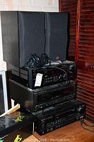 Stack of electronic devices including JVC RX-7000V receiver, Technics SL-MC400 CD changer, Sherwood TV-5030R receiver, topped with JBL bookshelf speakers with black grills.