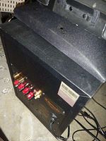 View of Klipsch speaker showing top and part of the casing with hole and dust.