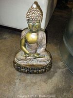 Front view of seated Buddha statue showing full figure and detailed decoration.