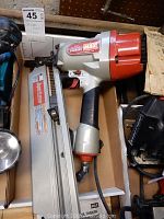 Max SN890RH SuperFramer framing nailer in original box showing silver and red housing and stick nail magazine