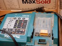 Makita battery charger DC18RA with LED indicators and power cord visible
