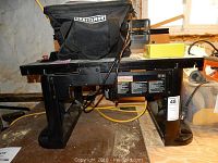 Front view of Craftsman router table with installed router and tool bag on top