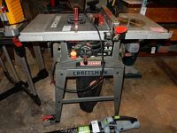 Full front view of the Craftsman table saw with stand and power cord visible on front and sides.