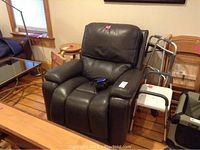 Dark grey leather LaZboy recliner chair shown with surrounding furniture and mobility aid, highlighting overall condition and color.