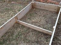 Image showing rectangular cedar planter box with an internal support beam and decorative finials on corners.