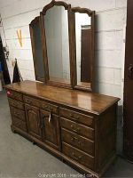 Front view of Drexel triple dresser with attached three-panel mirror showing overall condition and style.