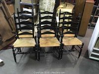 Front view of all six chairs arranged in two rows on concrete floor.