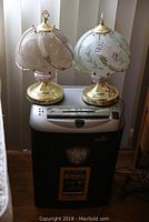 Two floral-patterned glass shade table lamps and Fellowes paper shredder, showing overall condition and appearance of all items.