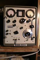 Front view of Hewlett Packard VHF signal generator model 608E with multiple dials, meters, and rotary controls.