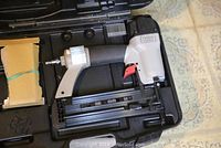 Porter Cable pneumatic nailer, gray and black, in plastic case with accessories
