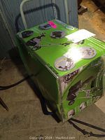 Photo of the original green retail box of the Earth Wise SN71018 snow thrower showing the packaging and metal cart included.