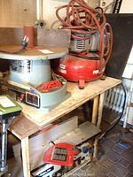 Wooden table supporting Delta planer and Porter-Cable compressor