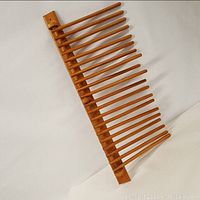 Top view showing entire wooden trouser rack with multiple rods spread out horizontally.