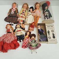 Full collection of 12 dolls including boxed Amish doll and varied dolls in different dresses and styles