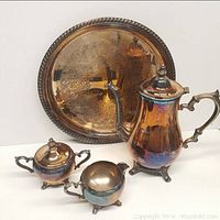 Photo showing the coffeepot, creamer, sugar bowl, and serving tray together, highlighting the overall set appearance and condition.