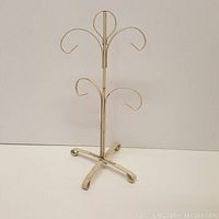 White painted metal coffee mug hanger displayed on a plain background, showing the entire piece including top hooks and base.