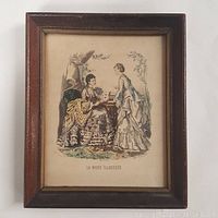 Frontal view of the framed antique colored print featuring two women in period dresses labeled La Mode Illustrée.