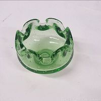Green Murano glass candy dish with ruffled rim and air bubbles inside