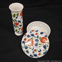 Photo showing the large bud vase and the covered dresser jar with lid removed, displaying floral porcelain design.