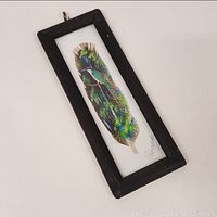 Framed feather painting showing full artwork and frame.