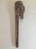 Full view of the vintage Trimont 18 inch crescent wrench showing overall rust and condition