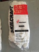Front view of the packaged mop head showing Skilcraft branding and product details.