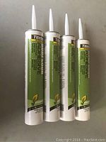 Four green Titebond Subfloor Adhesive tubes standing upright with white applicator nozzles visible.