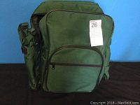 Front view of the green picnic backpack with a MaxSold tag attached