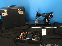 Full view of sewing machine on black case with accessories tray