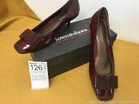 Pair of burgundy Town Shoes women's shoes displayed with box, showing front and top angle and fabric bow detail on toes.