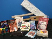 Sewing books, pattern books, and cutting ruler arranged on blue background