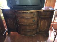 Front view of the antique carved wood buffet with visible light scratches and fading. Four curved central drawers and two side cabinets with oval inlays shown.