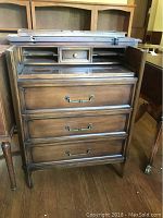 Child's wood desk with drawers open showing compartments and small drawer.