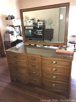 Front angle view of Henredon wooden buffet with mirror on top, showing 12 drawers, wood finish, and glass top protector.