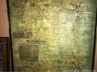 Close-up of painting showing green mottled background with collaged Chinese text block at lower left
