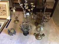 View showing metal candelabras, metal reindeer, and magazine rack with metal and glass candle holders on carpet
